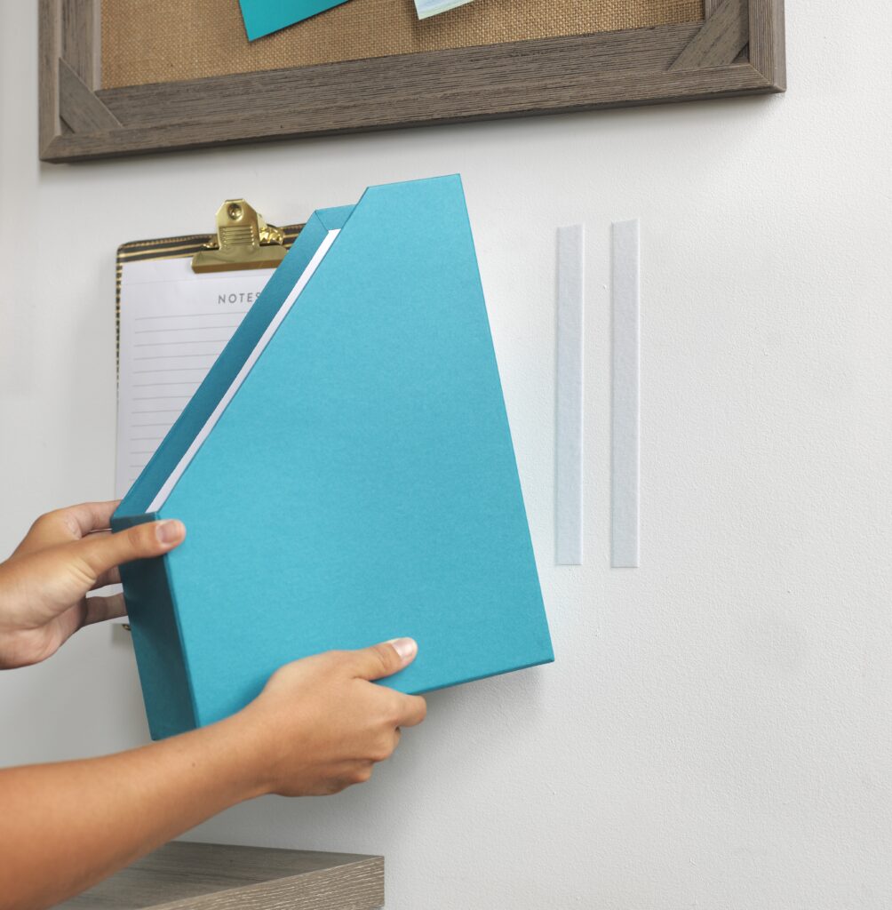 Folder for work being mounted to the wall for better organization using VELCRO® Brand HANGables® Removable Wall Fasteners