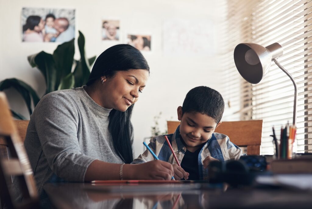 mom helping son with homework in neat and tidy homework station