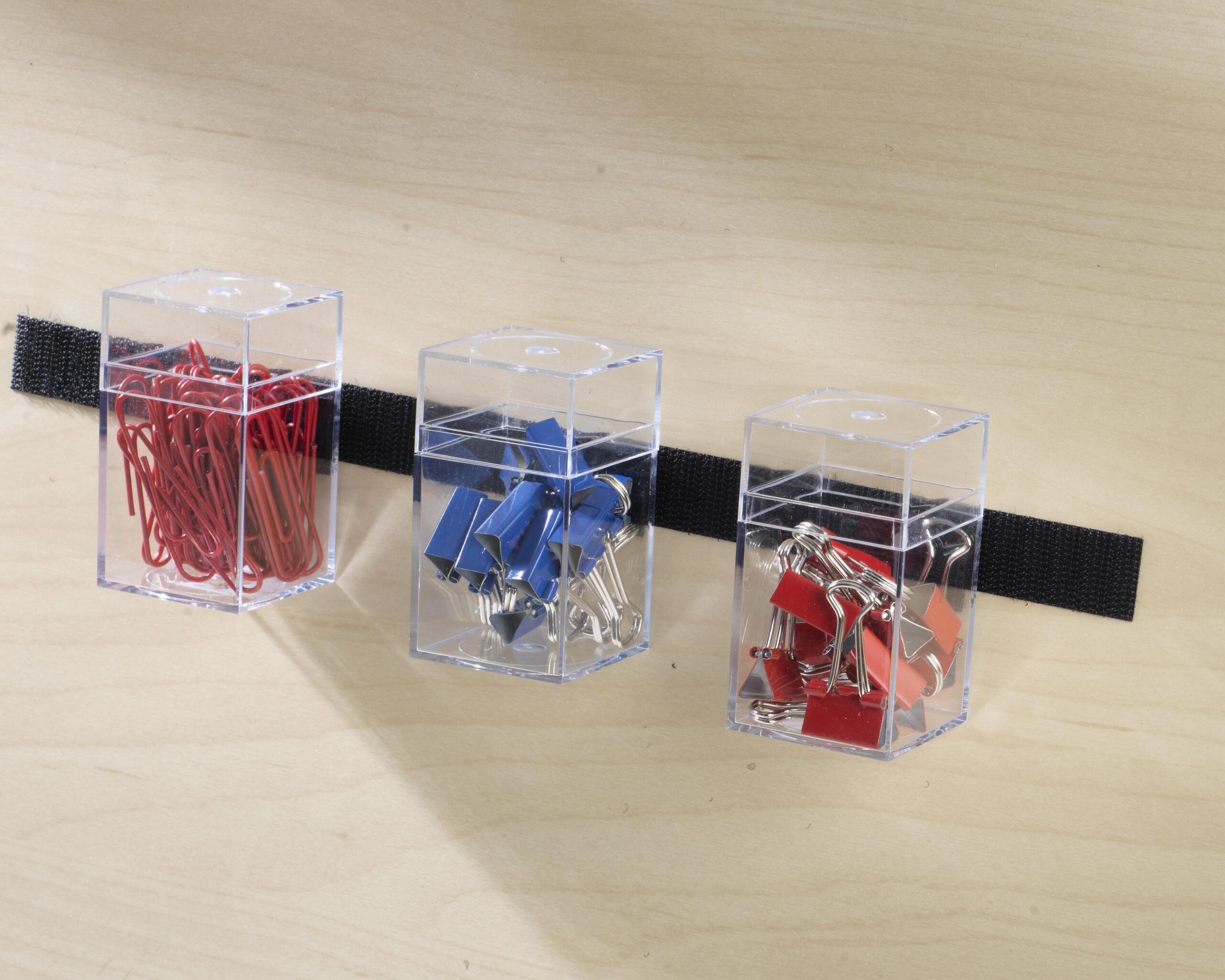 Office supplies stuck to wall using VELCRO® Brand Sticky Back Strips.