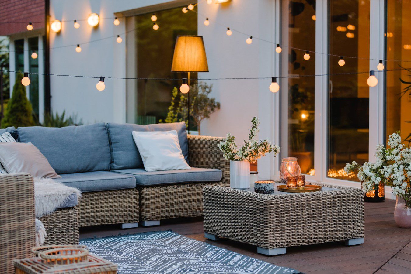 string lights hung up across an outdoor patio set on a deck