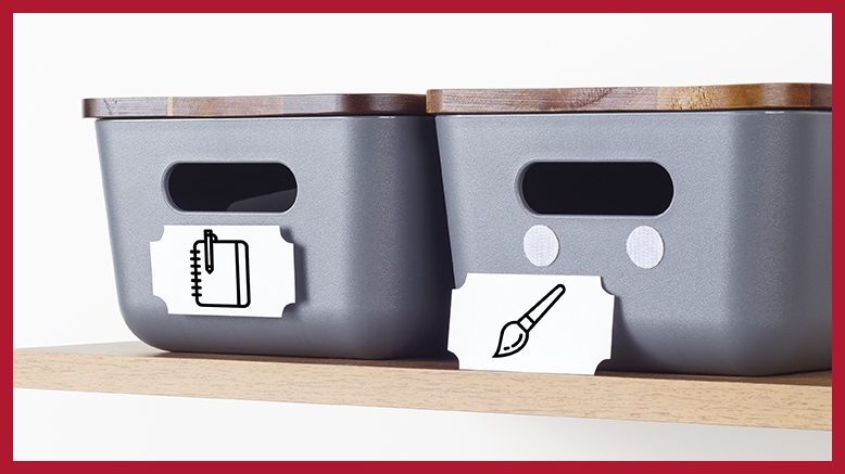 Two labeled storage bins with wooden lids organized on a shelf using VELCRO® Brand fasteners—ideal for home organization and craft storage with icons for notebooks and paint supplies.