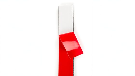 Backing peeled off VELCRO® Brand fastener on plain white background.