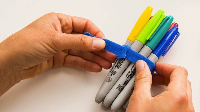 Permanent marker pens bundled together using VELCRO® Brand ONE-WRAP® Heavy Duty Ties for a tidier classroom.