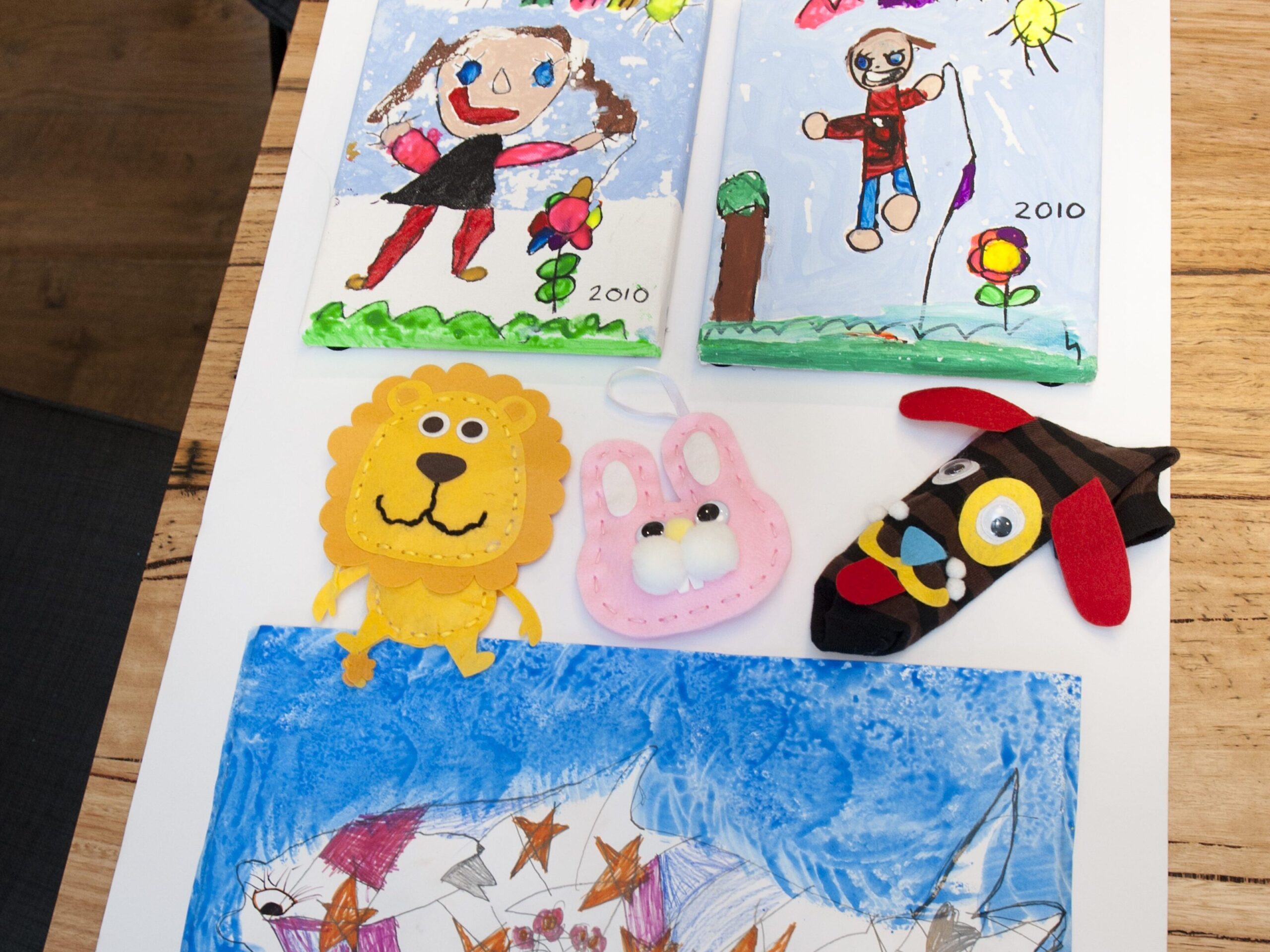 Kids artwork organized and ready for hanging using VELCRO® Brand Removable Mounting Squares
