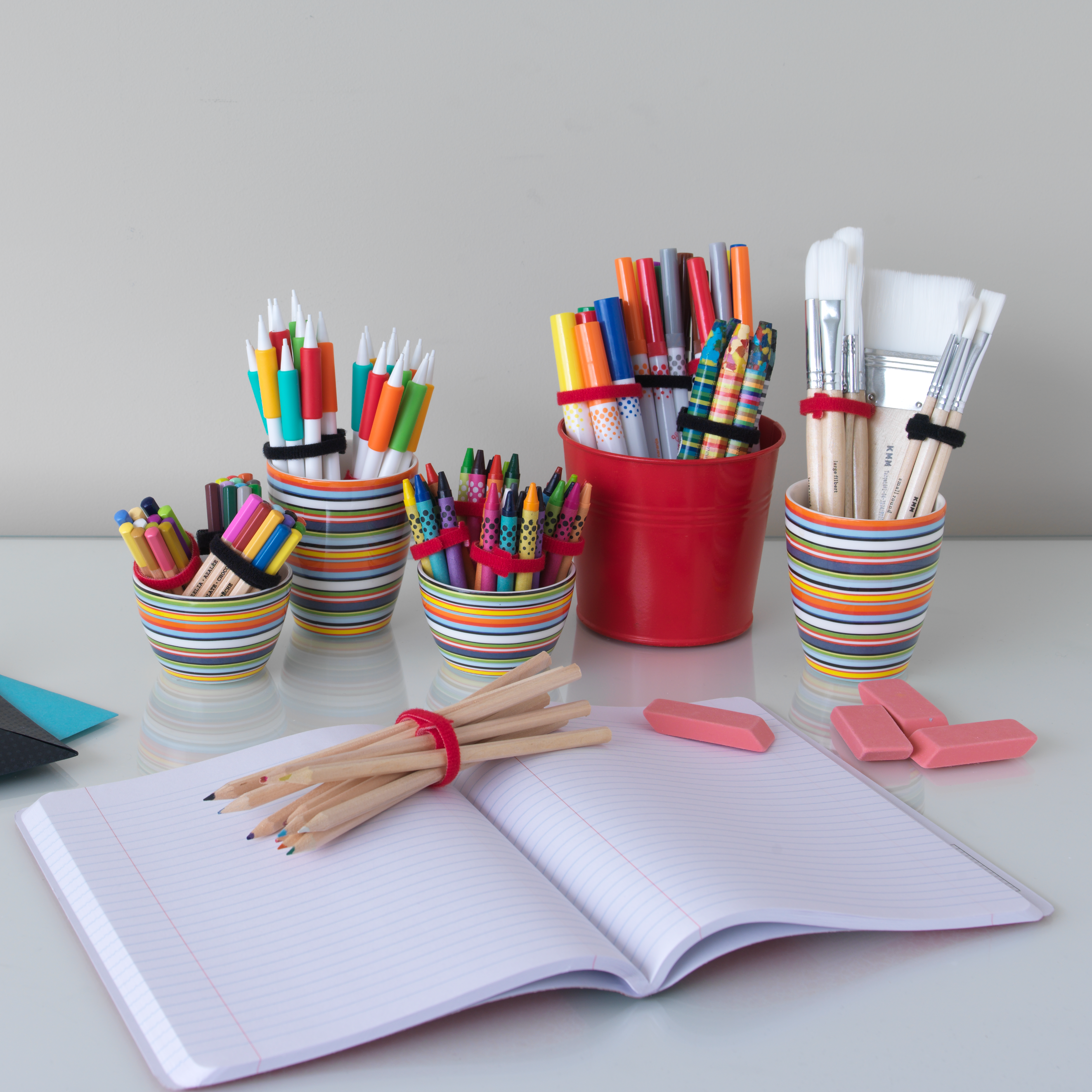 Homework station with pens, pencils and paintbrushes organized using VELCRO® Brand ONE-WRAP® Heavy Duty Ties.
