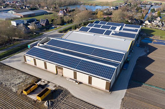 Commercial warehouse roof with solar panels attached using VELCRO® Brand fasteners.