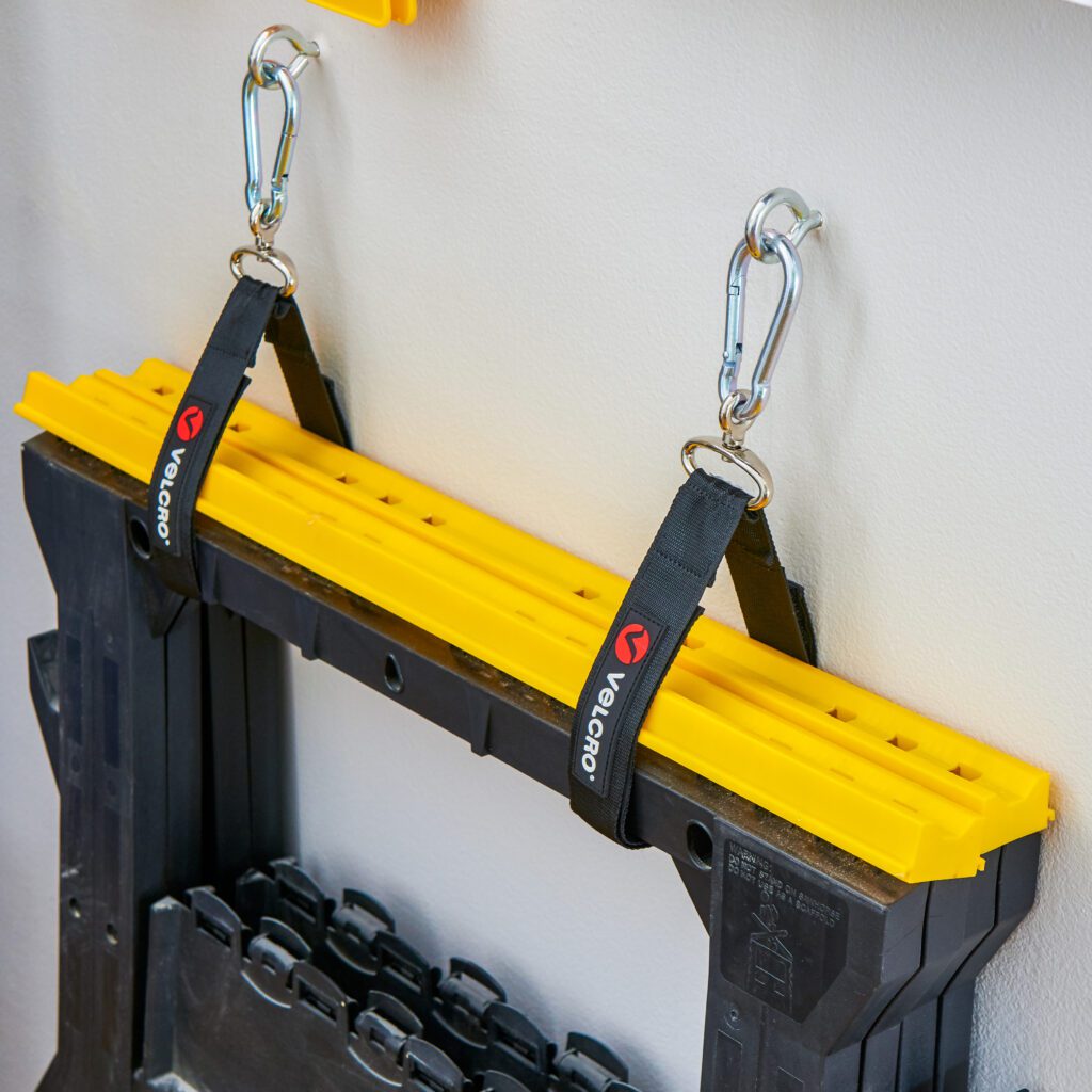 VELCRO® Brand EASY HANG™ Straps hanging sawhorse to wall.