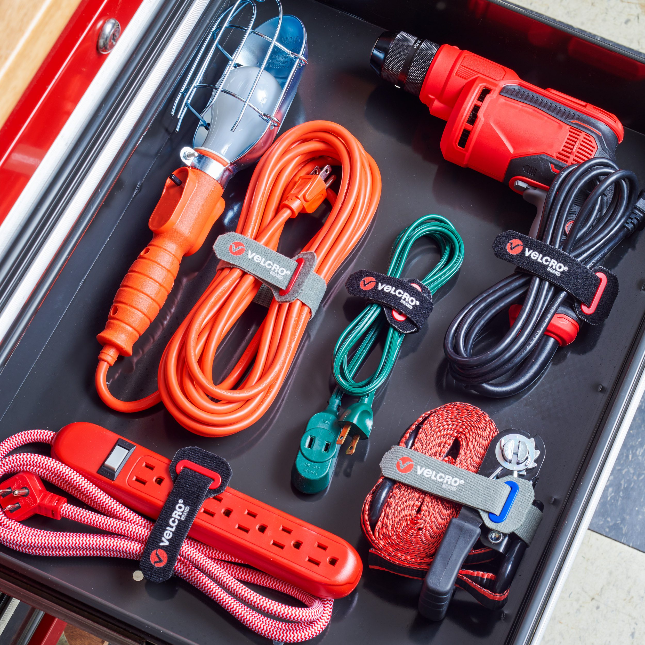 Drawer in tool chest with neatly organized cables using VELCRO® Brand Power Cord Wraps